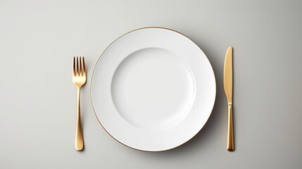 Details on the dining table,Top view of empty plate and gold cutlery on gray background