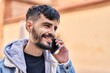 © Krakenimages.com - Young hispanic man smiling confident talking on the smartphone at street