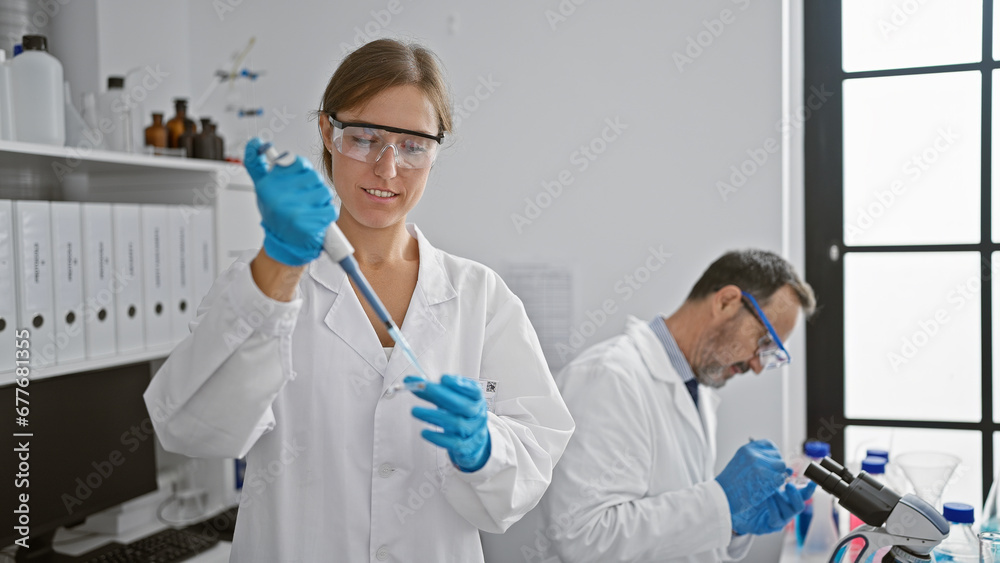Two joyful lab mates, woman and man, pouring liquid into a sample pipette together, navigating the path of medical science, gloves on for safety in a bustling laboratory interior.