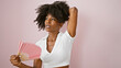 © Krakenimages.com - African american woman using handfan suffering for hot over isolated pink background