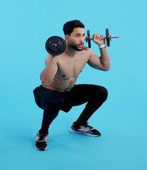 Poster - Man, fitness and squat with dumbbells for weightlifting, bodybuilding against a blue studio background. Male person or bodybuilder lifting weights for strength workout, exercise or training on mockup