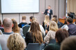 © Anton Gvozdikov - Back view of businesswoman attending presentation with diverse participants in conference hall