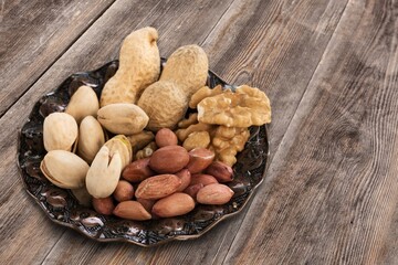 Sticker - mixed tasty nuts in bowl on the desk