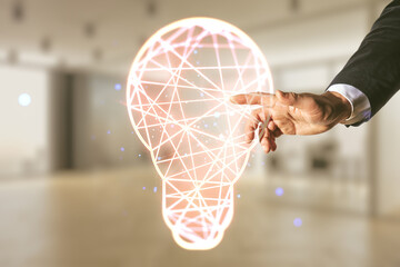 Fototapete - Man hand working with abstract virtual light bulb hologram on blurred office background, idea concept. Multiexposure