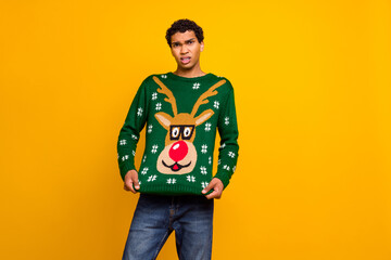 Canvas Print - Portrait of sullen unsatisfied person showing ugly christmas sweater empty space isolated on yellow color background