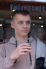 Young good-looking guy drinking coffee