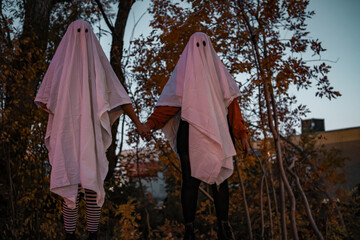 Friends Dressed in Homemade Sheet Ghost Costumes for Halloween