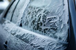 The windscreen of a car covered in frost and ice on a winter morning