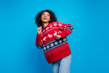 Sticker - Photo of crazy cheerful girl wear trendy ugly sweater looking empty space dancing winter event isolated on blue color background