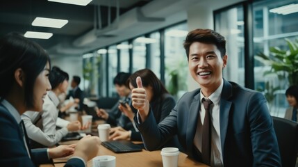 Poster - Asian office workers happily giving each other a high five in the office during a cheerful moment.