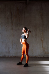 Wall Mural - Young female athlete training in a gym using sport equipment. Fit woman working out . Concept about fitness, wellness and sport preparation.