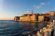 warm sunlight hit the city of Rovinj with the adriatic sea and rocks