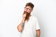 © luismolinero - Redhead man with long beard isolated on white background having doubts and thinking