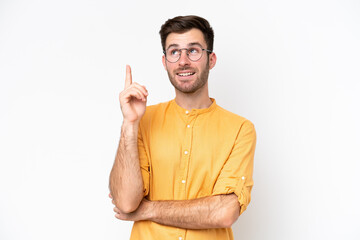 Wall Mural - Young caucasian man isolated on white background pointing up a great idea