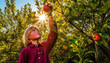 Healthy children enjoying organic apple harvesting in a rural orchard generated by AI