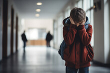 Upset Boy Covered His Face With Hands Standing Alone In School Corridor. Learning Difficulties, Emotions, Bullying In School