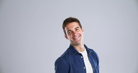 Poster - Face, happy and a confident young man in studio isolated on gray background to relax while feeling positive. Portrait, smile and casual with a handsome person from Brazil looking carefree or natural