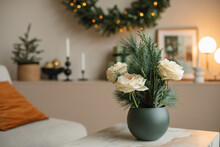 Stylish Floral Composition With Fir Branches In Vase On A Table In A Living Room Decorated For Christmas