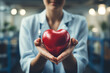 Smiling female cardiologist holding a red heart and showing the object to the camera. Happy doctor expressing support for patients with cardiovascular  examination to receive  ai generative