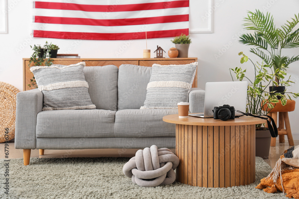 Interior of living room with USA flag, table and sofa