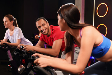 Sticker - Group of people training on exercise bikes in fitness club