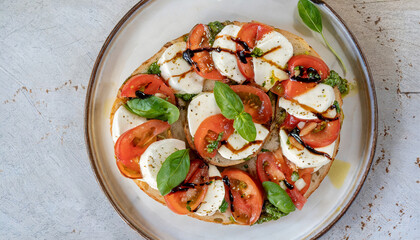 Wall Mural - A top-down shot captures the simplicity and beauty of a caprese bruschetta, with diced tomatoes, fresh mozzarella, and basil on toasted bread drizzled with balsamic glaze.