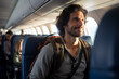© toonsteb - male backpacker traveler passenger Smiling on the plane in front of the passenger seat bokeh style background