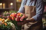 Fototapeta  - Man preparing bouquet of tulips in the store