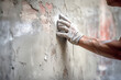 close up construction worker hand plastering on the white wall