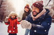 delighted family having fun, playing outdoor in snow. winter season activity