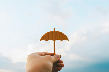 Wall Mural - Hand of man holding an umbrella symbol. Insurance concept, Family life insurance and policy concepts