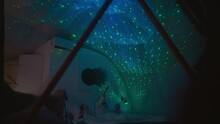 Relatives Rest With Reflection Of Night Sky On Ceiling