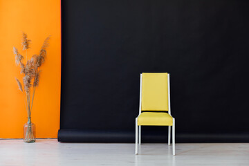 Sticker - Interior of a black and orange room with colored chairs, armchairs