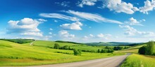 Country Road In Green Field And Blue Sky With Clouds. Panoramic View.
