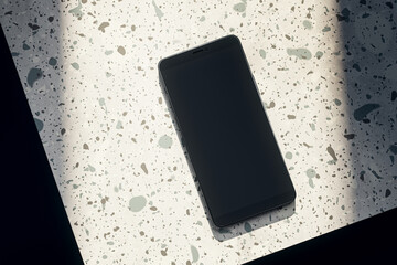 Wall Mural - Top view of empty black smartphone on spotted table. Mock up, 3D Rendering.