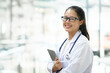 © ijeab - Confident smiling doctor posing and looking at camera.