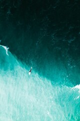 Aerial top view of person surfing in the sea waves in Florida