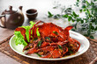 © perfectloop - traditional chinese wok fried seafood fresh big meat crab with black pepper spicy sauce in plate on grey vintage background asian cafe hotel luxury halal food restaurant banquet menu