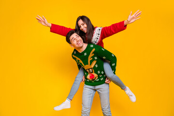 Poster - Photo of positive cheerful lovers lady guy playing on x mas occasion piggyback isolated bright color background