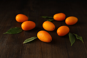 Sticker - Kumquat and leaves on dark wooden background