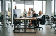 © standret - By the table and with whiteboard. Group of office workers are together indoors