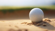 A golf ball perched on the lip of a sand trap,  not yet sunk