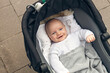 © Ulrika Kestere - Happy baby boy lying in stroller looking up