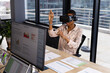 © Wavebreak Media - African american casual businesswoman wearing vr headset using virtual interface at desk in office