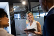 © Wavebreak Media - Happy diverse male and female colleagues brainstorming at glass wall and using tablet in office