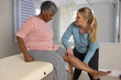 © Wavebreak Media - Caucasian female physiotherapist treating senior afrcian american female patient, copy space
