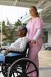 © Wavebreak Media - Happy caucasian female nurse and senior african american female patient in wheelchair