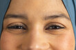 © Wavebreak Media - Portrait of happy eyes of biracial woman in hijab at sunny home