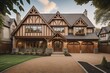 Tudor style family house exterior with gable roof and timber framing. Wooden garage doors in home cottage