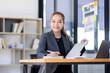© David - Business asian woman working at office with documents on his desk, doing planning analyzing the financial report, business plan investment, finance analysis concept